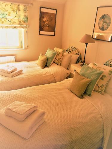a bedroom with two beds with towels on them at Carlton Towers Stapleton's & Parkgate's in Carlton