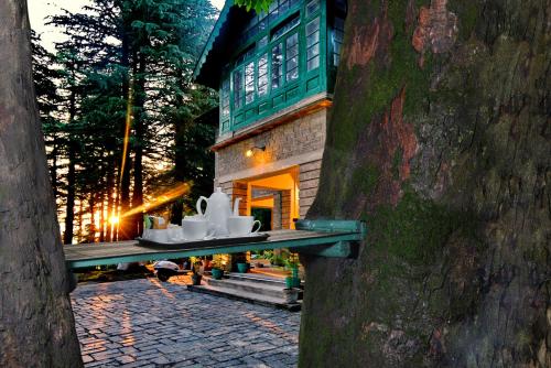 a house with some white dishes on a ledge at Brij Villa, Dalhousie - A Colonial Luxury Retreat in Dalhousie