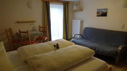 a living room with a couch and a blue at Haus Bergheim in Sankt Leonhard im Pitztal