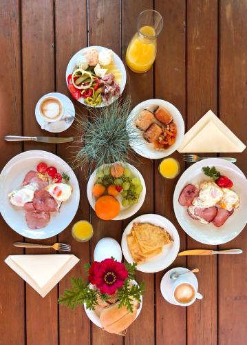 a wooden table with plates of food on it at Guesthouse Smogavc in Zreče