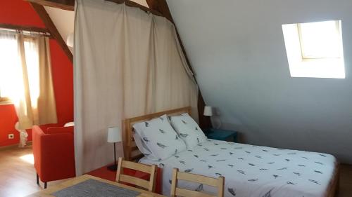 a bedroom with a bed with a canopy at Le charme du château in Les Andelys