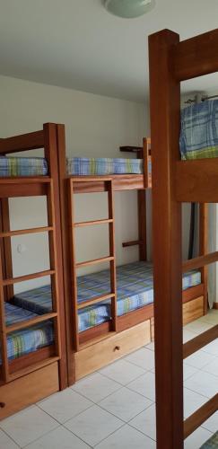 two bunk beds with their doors open in a room at Surf House Hostel in Santa Maria