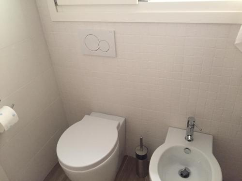 a small bathroom with a toilet and a bidet at Modern Flat Lecce ++ in Lecce