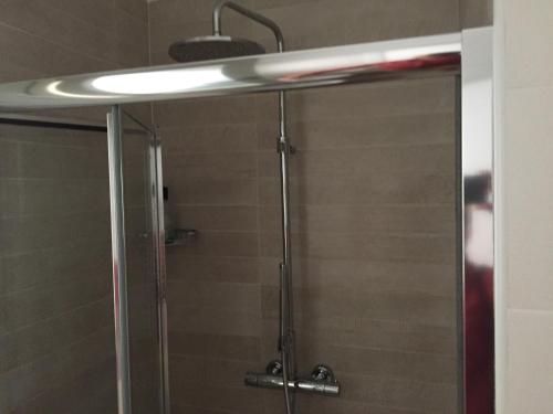 a shower with a glass door and a light at Modern Flat Lecce ++ in Lecce
