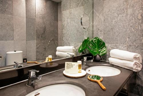 a bathroom with two sinks and a mirror at Chic & Basic Velvet in Barcelona