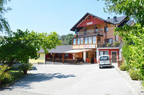 a car parked in front of a building at Gostilna s prenocisci Danica in Slovenska Bistrica