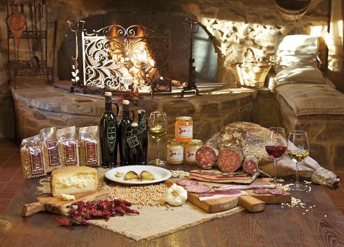a table with a bunch of food and bottles of wine at Agriturismo Le Calle in Cinigiano