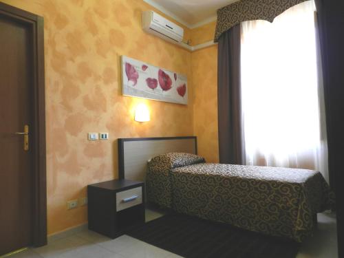 a bedroom with a bed and a window at Hotel Air Palace Lingotto in Turin