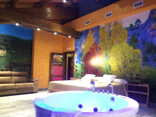a room with a bed and a bath tub at Hotel SPA El Lagar de Isilla in La Vid y Barrios