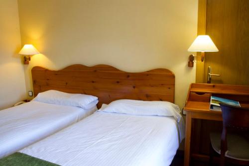 Letto o letti in una camera di Hotel Vall de Núria