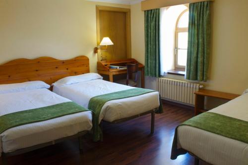 Letto o letti in una camera di Hotel Vall de Núria