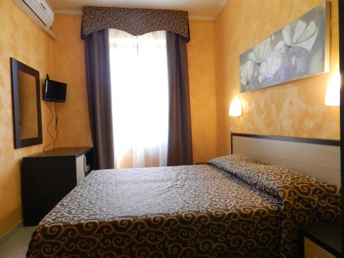 a bedroom with a bed in front of a window at Hotel Air Palace Lingotto in Turin