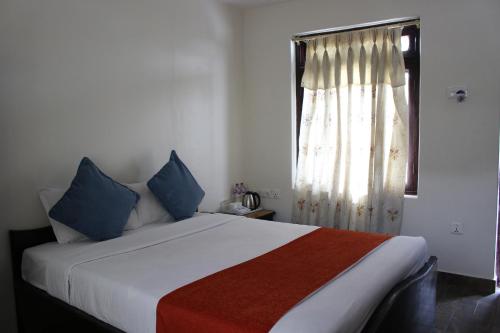 a bedroom with a large bed with a window at Tuki Resort Pokhara in Pokhara
