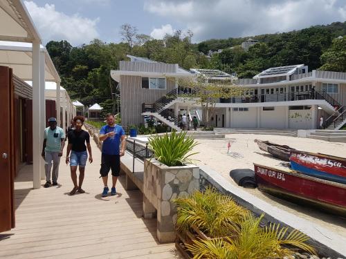 a group of people walking down a sidewalk near a house at Skycastle Oasis in Ocho Rios