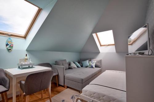 a living room with a couch and a table at Apartament Baltic Star Rewal in Rewal