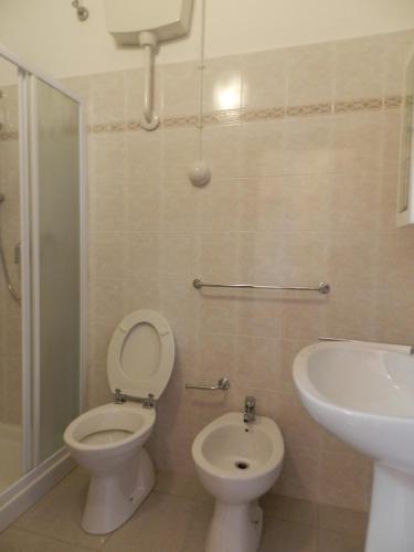 a bathroom with a toilet and a sink at Hotel Air Palace Lingotto in Turin