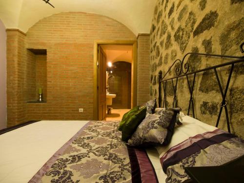 a bedroom with a bed in a brick wall at El Casino de Santa Cruz in Santa Cruz de la Sierra