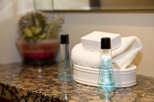 two bottles ofodorizers sitting on a granite counter top at Whitley Hall Hotel in Chapeltown