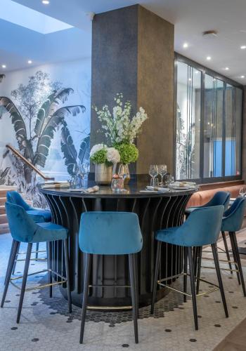 a dining room with a table and blue chairs at The Morgan Hotel in Dublin