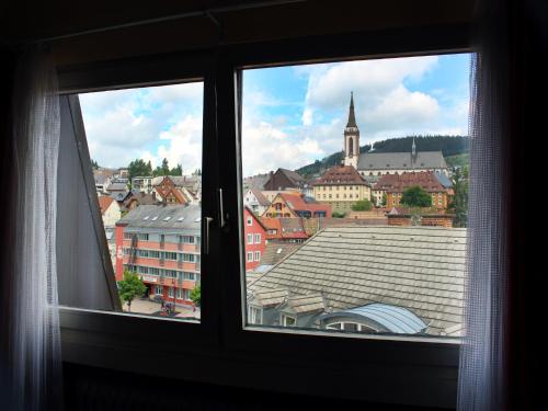 a view of a city from a window at Hotel Neustädter Hof in Titisee-Neustadt