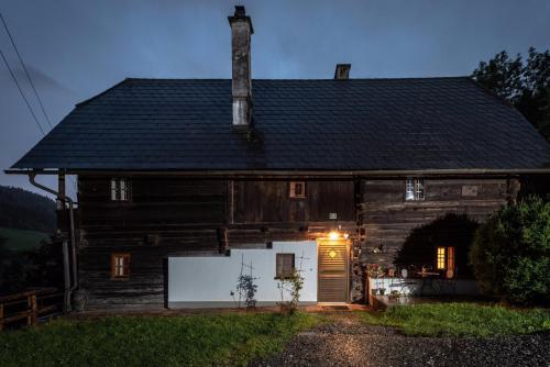 an old house with a garage in front of it at Urlaub auf der Alm "Deluxe" in Preggraben