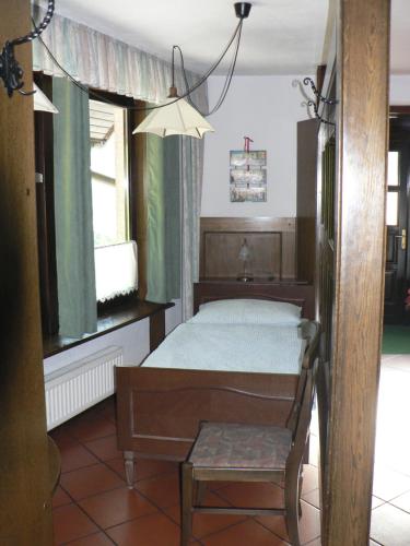 a bedroom with a bed and a chair in it at Apartmaji Mak in Jesenice