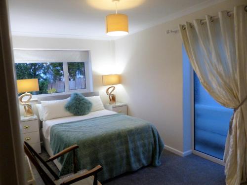 a bedroom with a bed and a window at Menhyr in Carbis Bay