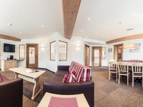 a living room with a couch and chairs and a table at Leni Mountain Appartements in Sölden