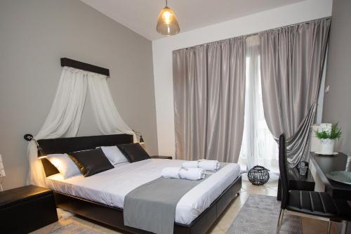 a bedroom with a bed with two towels on it at Villa Deluxe Sight in Ioannina