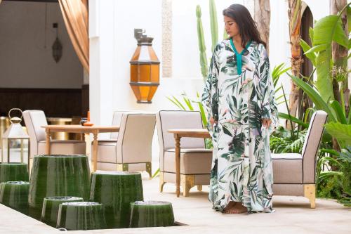 a woman in a kimono standing in a patio at Dar Kandi in Marrakech