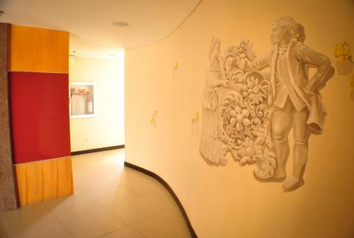 a statue of a man on a wall in a hallway at Hotel Elizabeth Cebu in Cebu City