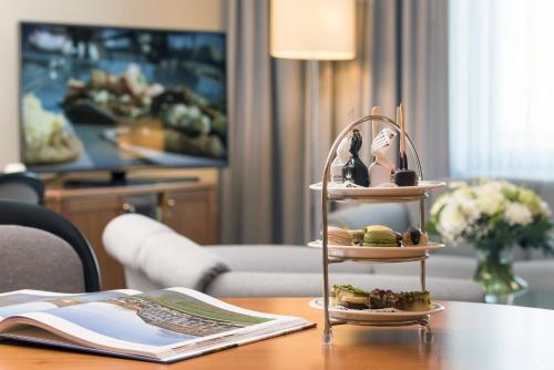 a table with a shelf with some food on it at Maritim Airport Hotel Hannover in Hannover