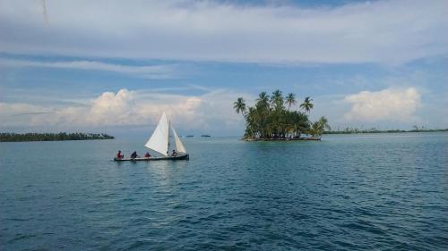 a boat with three people on it in the water at Play to Live San Blas in El Porvenir