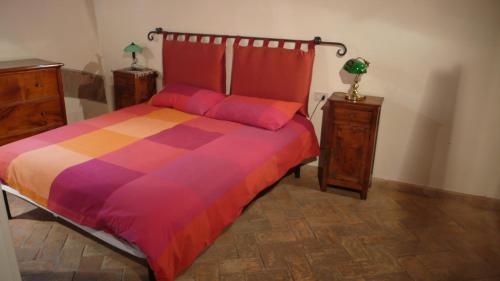 a bedroom with a bed with a colorful comforter at Le Camere di Casa Cassandra in Perugia