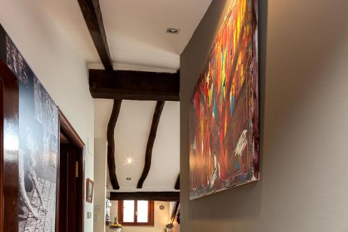 a painting hanging on a wall in a hallway at Apartamento Ondarroa in Ondárroa