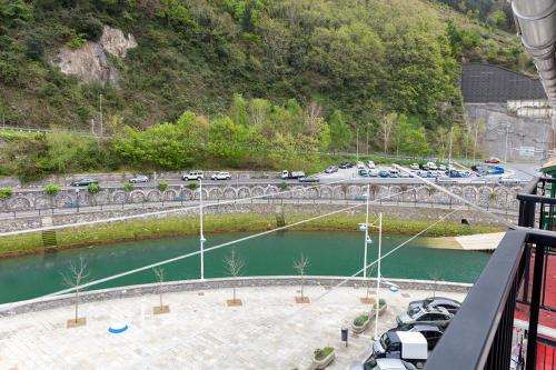 a bridge over a river with cars on a freeway at Apartamento Ondarroa in Ondárroa