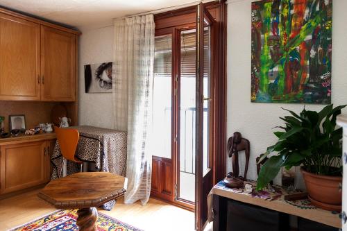 a living room with a sliding glass door and a table at Apartamento Ondarroa in Ondárroa