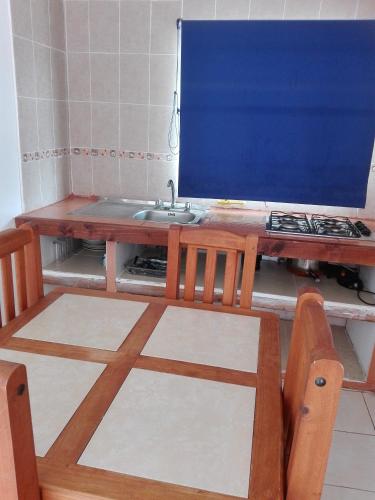 a wooden table with a sink in a kitchen at Cabañas con piscina donde Thomas in La Serena