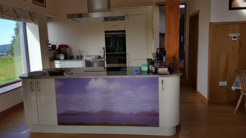a kitchen with a counter with a painting on it at Wester Blackpark Farm in Inverness