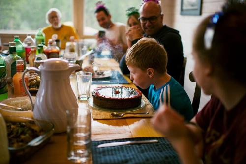 a group of people sitting at a table with a birthday cake at Devils Tower Lodge in Devils Tower