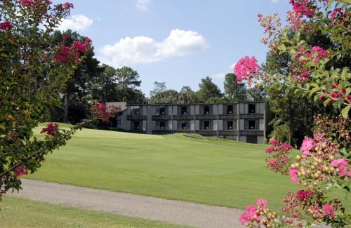una vista del hotel desde el campo de golf con flores en The Inn at Houndslake, en Aiken