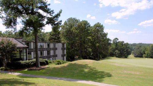 a building on a golf course with a green at The Inn at Houndslake in Aiken