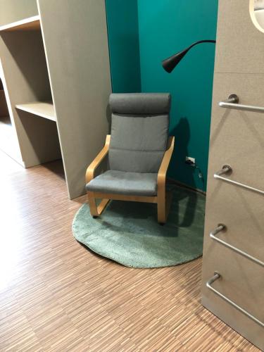 a chair sitting on a rug in a room at Andaina in Sarria