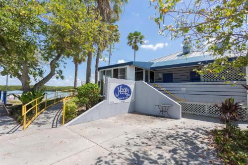 a house with a sign on the side of it at TAMPA BAY, BEACH step away, WIFI, FREE PARKING,POOLS, JACUZZI in Ruskin