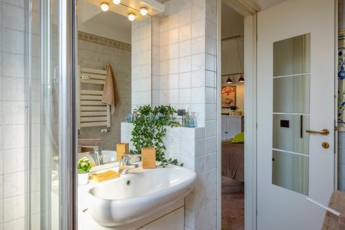 a white bathroom with a sink and a shower at The Best Rent - City View Apartment in Milan