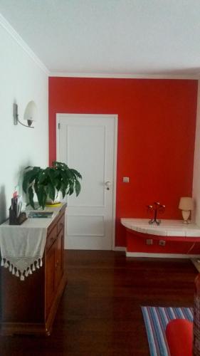 a red room with a sink and a red wall at Varanda do Atlântico in Ponta Delgada