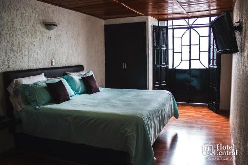 Una cama o camas en una habitación de Hotel Central Teziutlan