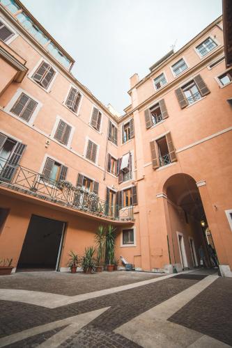 a large brick building with a courtyard in front of it at Trevi Portrait in Rome