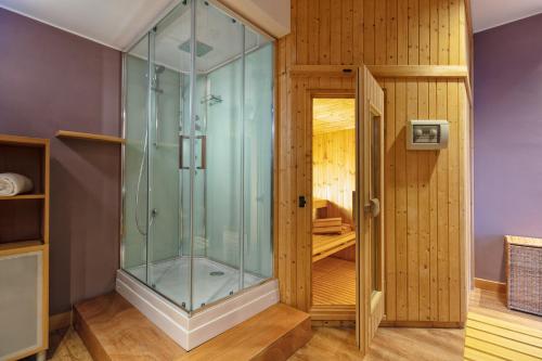 a shower with a glass door in a room at Garda Hotel in Montichiari