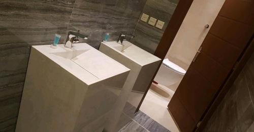 a bathroom with two sinks and a mirror at Swarvoski Chalet in Riyadh